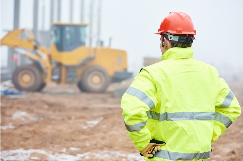 construction-industry | Fast Labour Hire an image of a construction worker monitoring and supervising the construction operations at a construction site